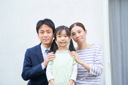Photo for Commemorative photo of three parents and their child at their home - Royalty Free Image