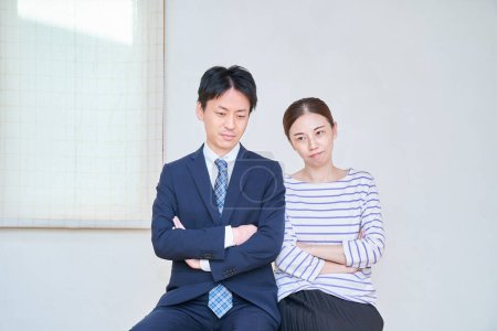 Photo for Worried couple with folded arms in the room - Royalty Free Image