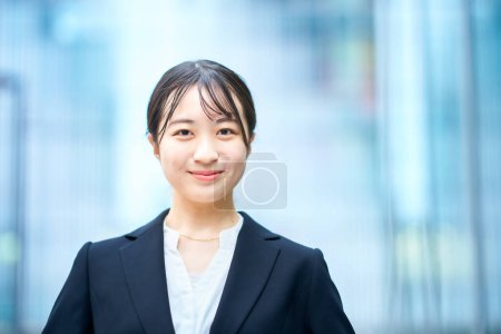 asian young woman in suit outdoors