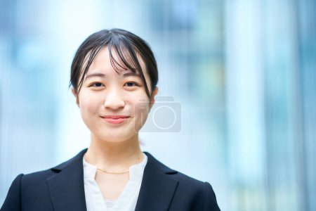 asian young woman in suit outdoors