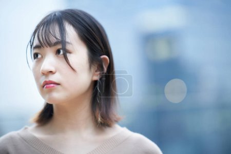 Photo for Young woman with calm expression outdoors - Royalty Free Image