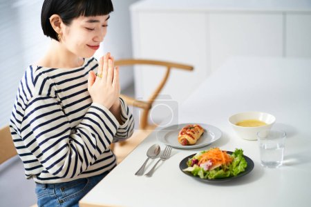 Foto de Mujer comenzando una comida en el comedor en casa - Imagen libre de derechos