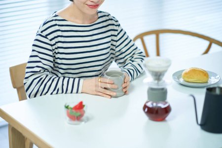 Photo for Young woman drinking coffee in the room - Royalty Free Image