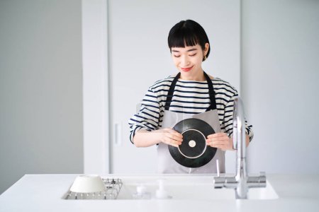 Photo for Young woman washing dishes in the kitchen - Royalty Free Image