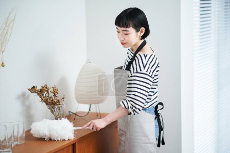 Photo for Asian young woman cleaning the room - Royalty Free Image