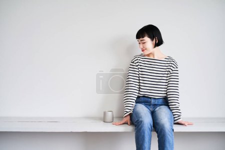 Photo for Asian young woman relaxing in the room - Royalty Free Image