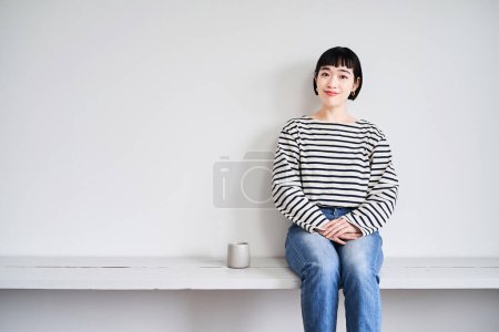 Photo for Asian young woman relaxing in the room - Royalty Free Image