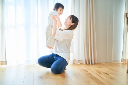 Photo for Mother and child hugging in the room - Royalty Free Image