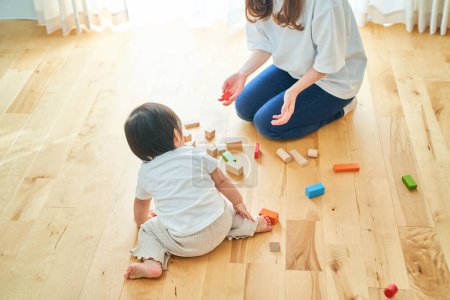 Photo for Mother and child playing with building blocks in the room - Royalty Free Image