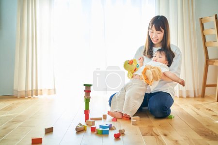 Photo for Mother and child playing with puppets - Royalty Free Image