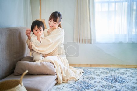 Photo for Mother and child hugging in the room - Royalty Free Image
