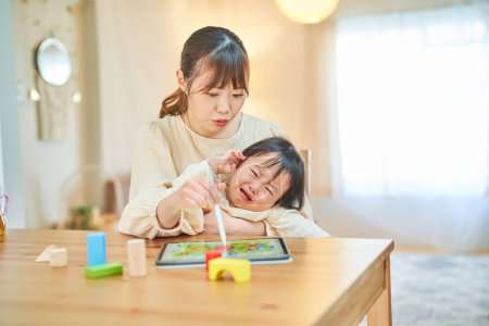 mother and little boy playing with a tablet PC
