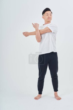 Photo for Middle-aged man wearing sportswear indoors and white background - Royalty Free Image