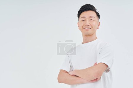Photo for Middle-aged man wearing sportswear indoors and white background - Royalty Free Image