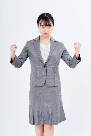 Photo for A woman in a suit who is stressed and white background - Royalty Free Image