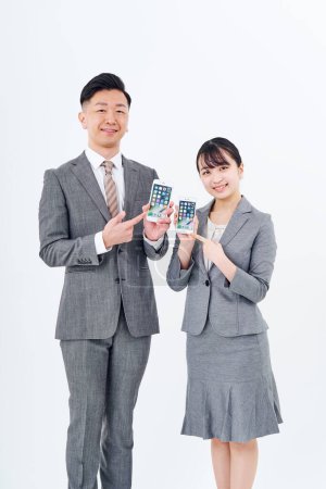 Photo for Man and woman in suits with smartphones and white background - Royalty Free Image