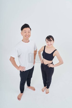 Photo for Man and woman in sportswear and white background - Royalty Free Image
