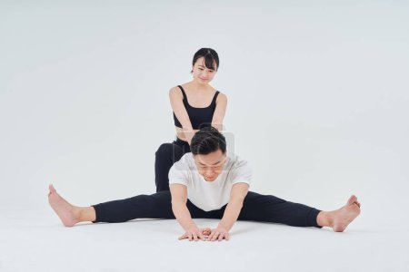 Photo for Man and woman doing stretching exercise and white background - Royalty Free Image