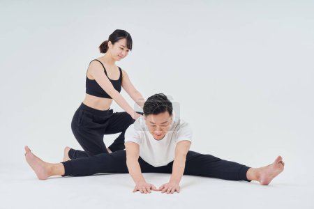Photo for Man and woman doing stretching exercise and white background - Royalty Free Image