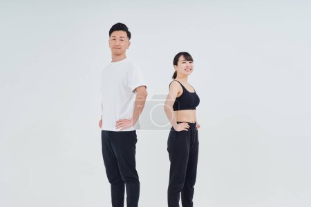 Foto de Man and woman in sportswear and white background - Imagen libre de derechos