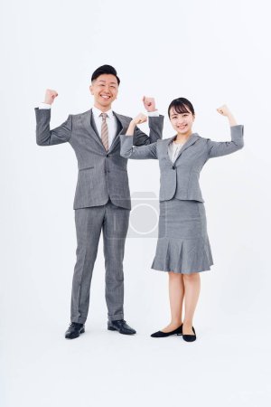 Téléchargez les photos : Homme et femme en costume posant positivement et fond blanc - en image libre de droit