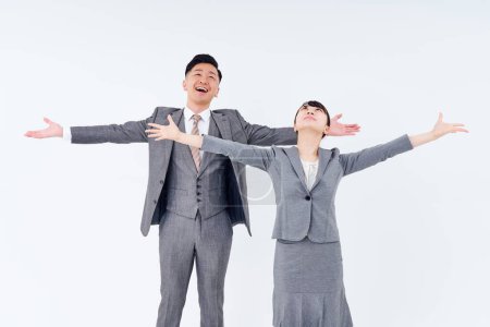 Photo for Man and woman in suits posing positively and white background - Royalty Free Image
