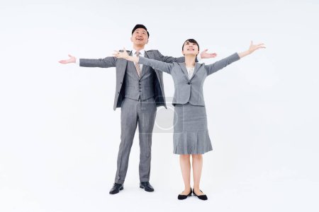 Téléchargez les photos : Homme et femme en costume posant positivement et fond blanc - en image libre de droit