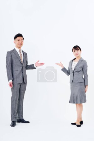 Photo for Man and woman in suits posing for guidance and white background - Royalty Free Image