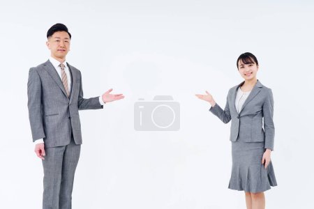Foto de Man and woman in suits posing for guidance and white background - Imagen libre de derechos