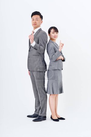 Photo for Man and woman in suits posing positively and white background - Royalty Free Image