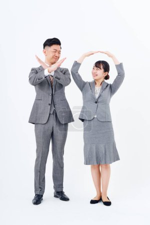 Photo for Man and woman in suits posing OK and NG and white background - Royalty Free Image