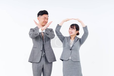 Foto de Man and woman in suits posing OK and NG and white background - Imagen libre de derechos