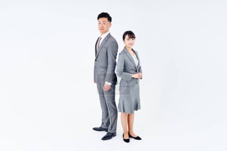 Foto de Man and woman in suits and white background - Imagen libre de derechos