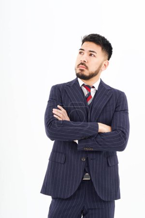 Photo for A man in a suit posing in thought and white background - Royalty Free Image