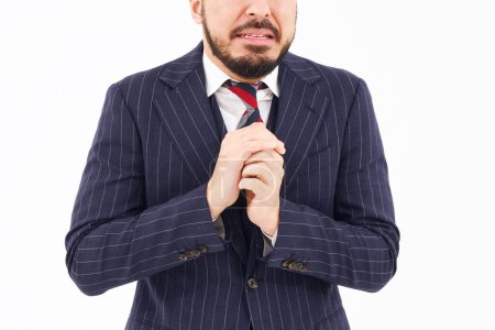 Téléchargez les photos : A man in a suit with a sad expression and white background - en image libre de droit