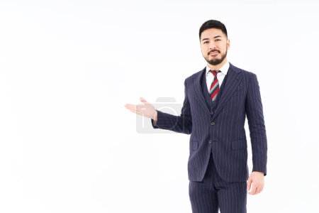 Photo for A man in a suit posing for guidance and white background - Royalty Free Image