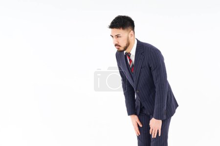 Photo for A man in a suit who poses to apologize and white background - Royalty Free Image