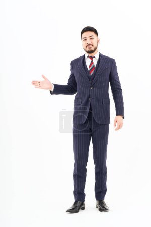 Foto de A man in a suit posing for guidance and white background - Imagen libre de derechos