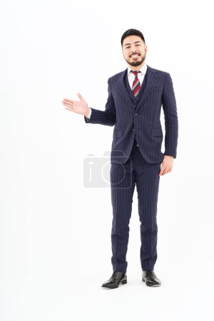 Photo for A man in a suit posing for guidance and white background - Royalty Free Image