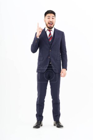 Photo for A man in a suit posing with his index finger up and white background - Royalty Free Image