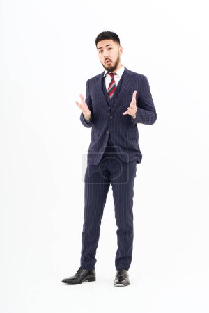 Photo for A man in a suit posing in thought and white background - Royalty Free Image