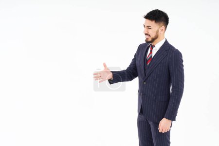 Photo for A man in a suit asking for a handshake and white background - Royalty Free Image