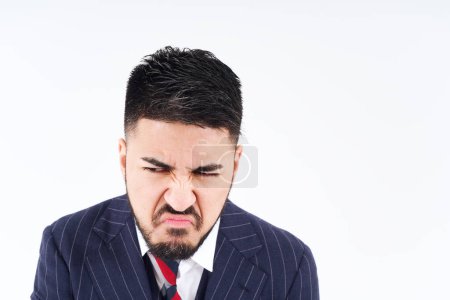Photo for A man in a suit with a stressed expression and white background - Royalty Free Image