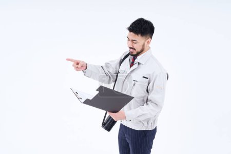 Foto de Business person in work clothes confirming pointing and white background - Imagen libre de derechos