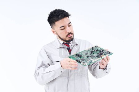 Photo for A man in work clothes with a computer board  and white background - Royalty Free Image