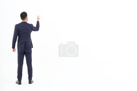 Photo for A man in a suit posing to write with a pen and white background - Royalty Free Image