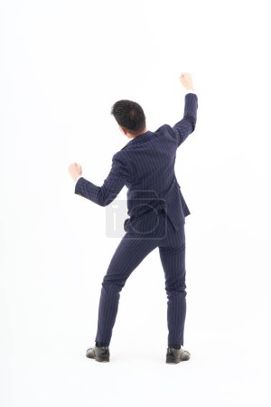 Téléchargez les photos : A man in a suit expressing joy and white background - en image libre de droit