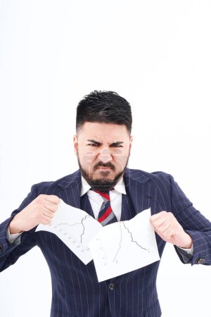 Photo for A man in a suit tearing up materials and white background - Royalty Free Image