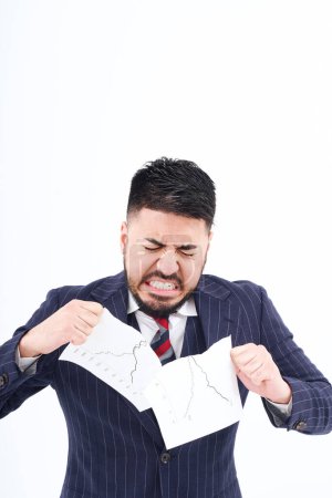 Photo for A man in a suit tearing up materials and white background - Royalty Free Image