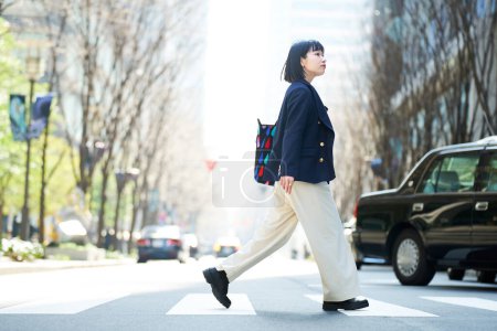 A young woman commuting to work or going out on a fine day